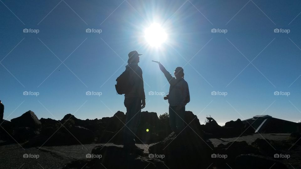 Checking out the sunset over the volcanic crater above the clouds.