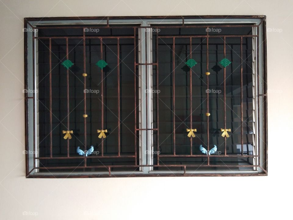 Beautiful pattern  of wrought iron bars on the window.