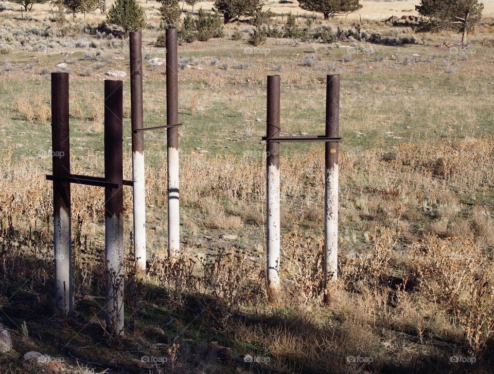 Old pipe frame in the ground showing the history of the area from abandoned industrial site converted to city park in Prineville in Central Oregon on a sunny winter day. 