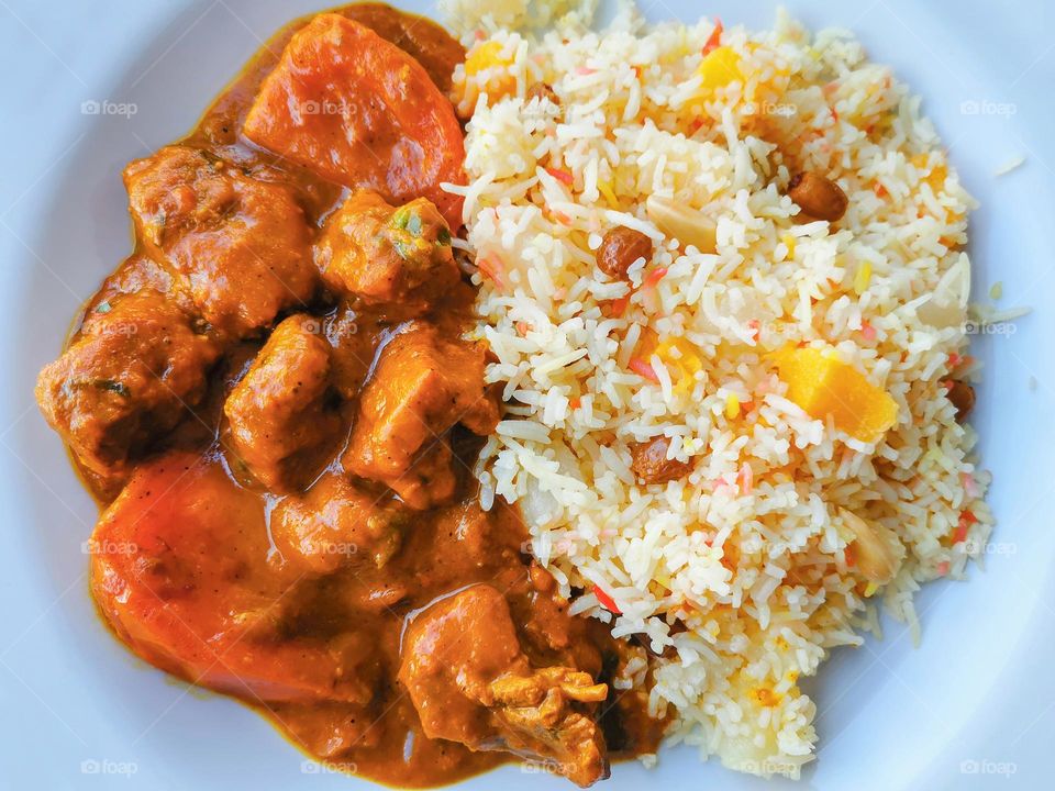 Lamb vindaloo with fried rice.  Traditional Indian curry.