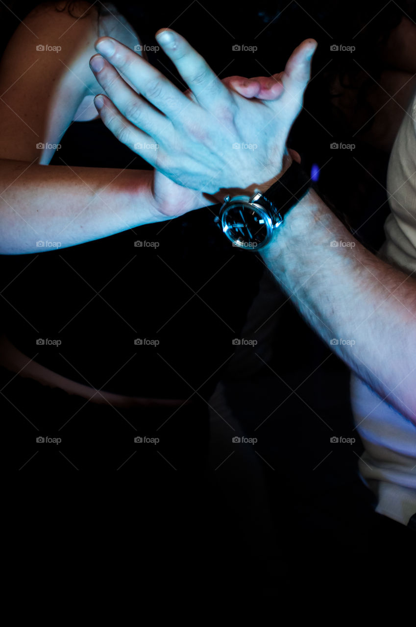 Couple holding hands together during the dance 