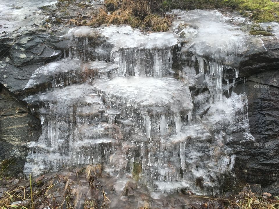 Frozen waterfall on rocks