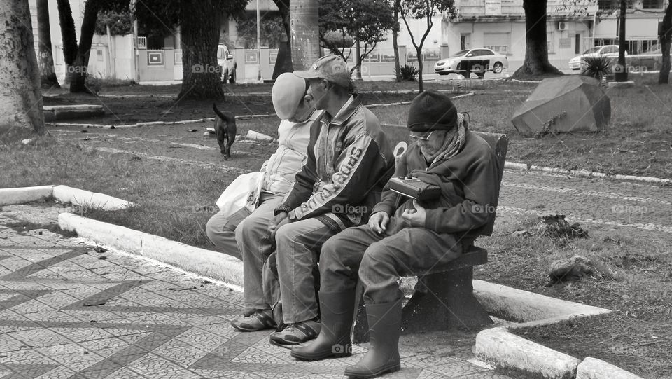 Old gentlemen sitting on the square bench