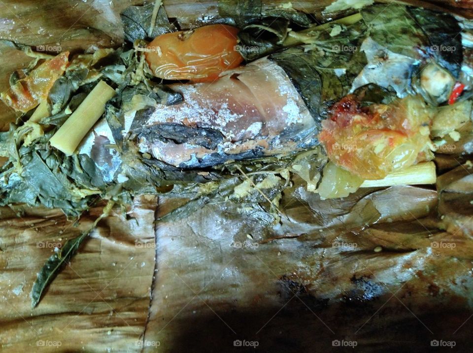 Steamed fish wrapped in leaves