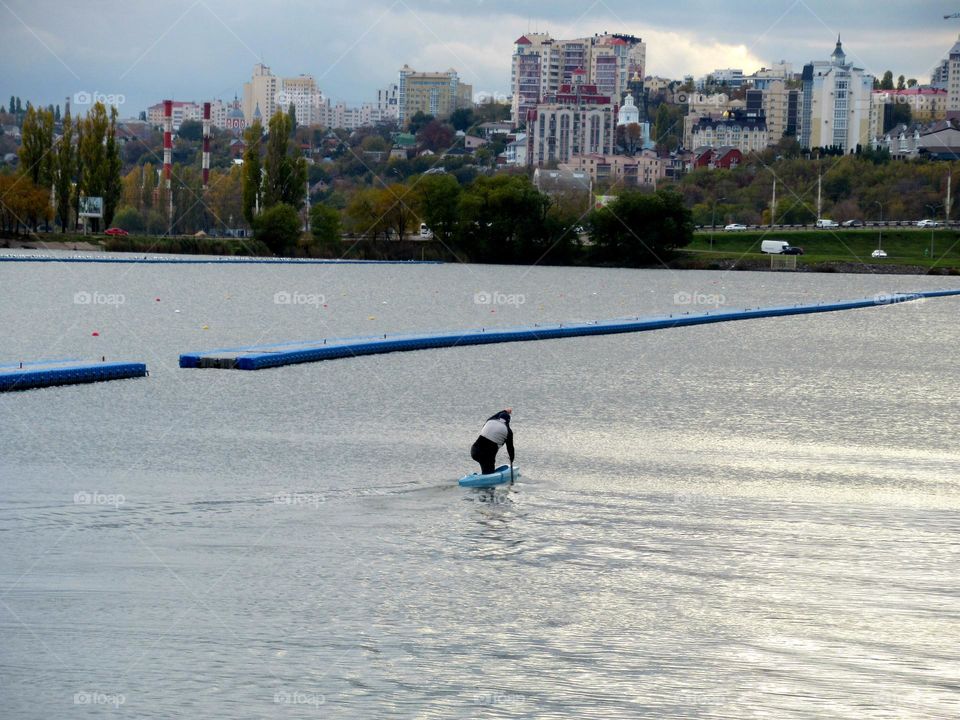 a man with a paddle kayak on the river, october, city of Voronezh, Russia,