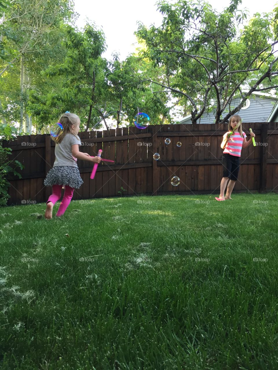 Summer Fun. Kids blowing bubbles