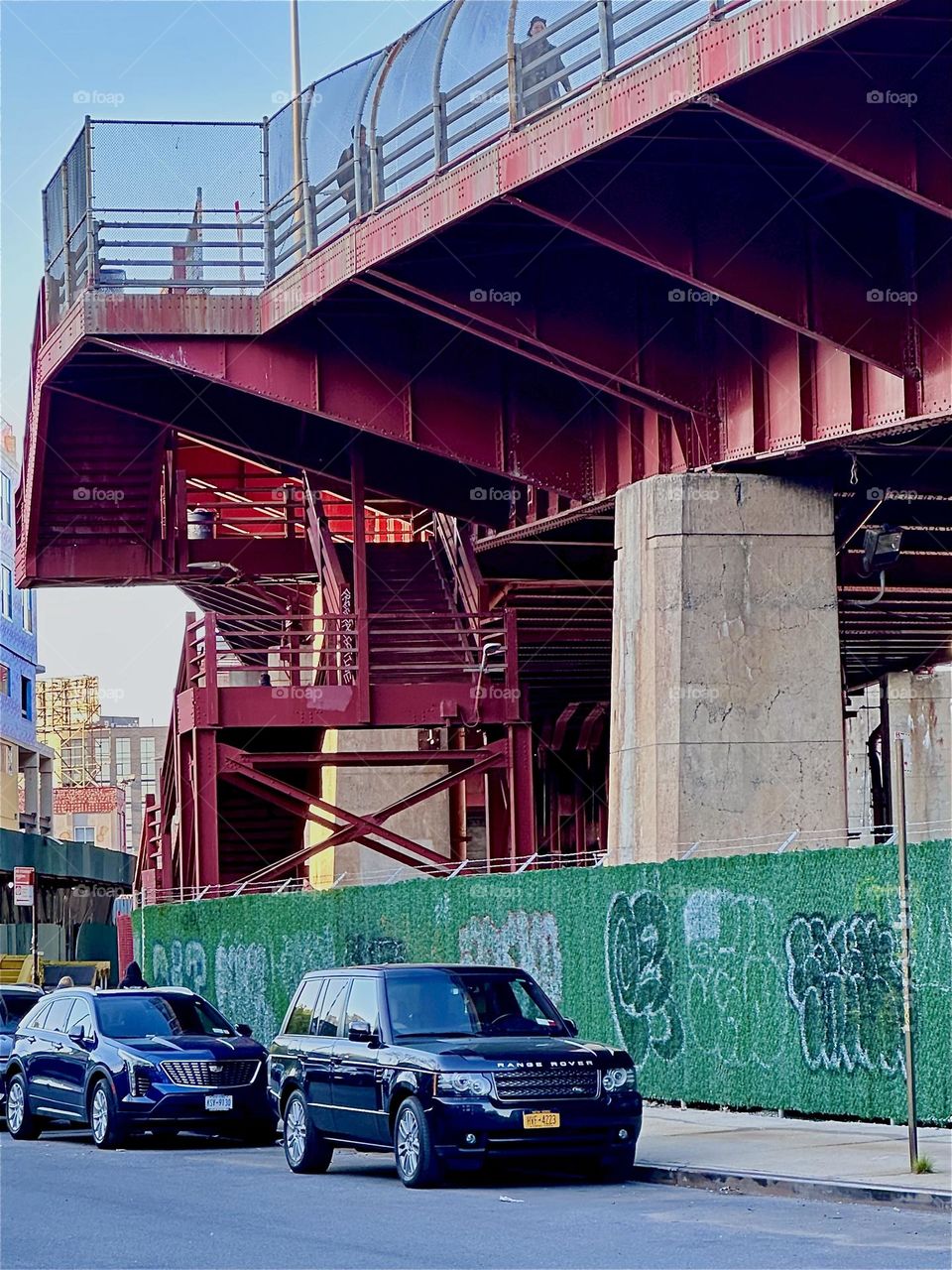 This is the red metal staircase of the “Pulaski Bridge” in “Greenpoint”, Bklyn at “Newtown Creek”. The bridge opened for traffic in 1954 but its style is influenced by the “Bauhaus” school of “Weimar”, Germany in the 1930s. 2024. Hypnotic Productions