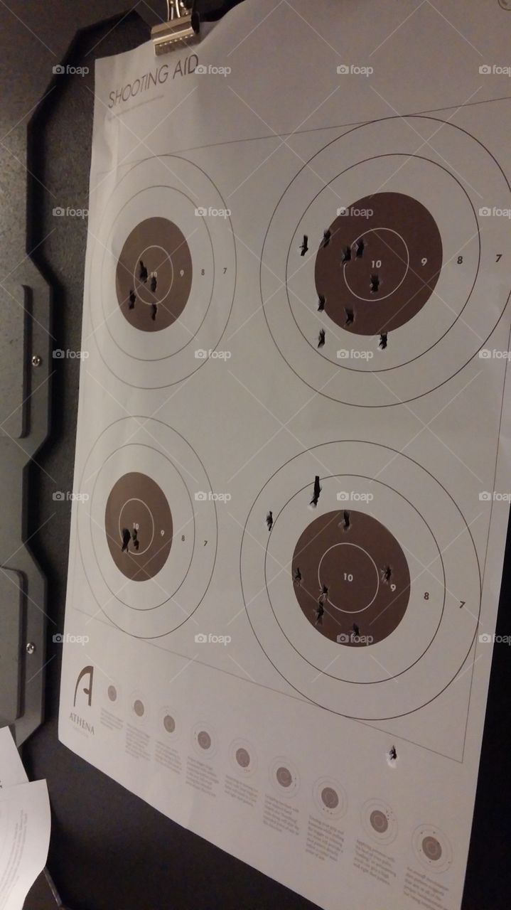 Day at the Range. This was my first time shooting a gun. Mine are on the right, my guy's is left. Remind me not to get on his bad side. ;)