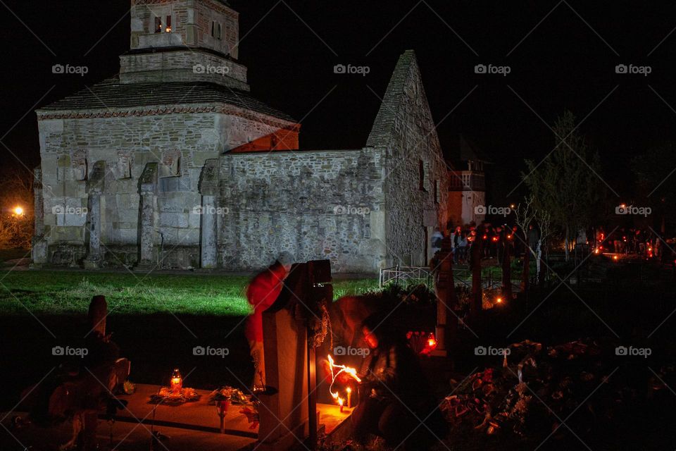 Lighting candles at the graves in Easter night