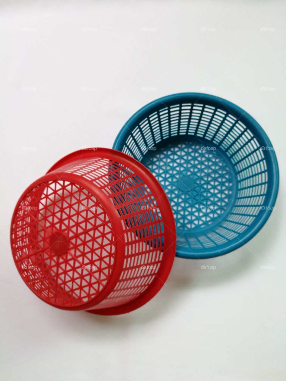 Red and blue  plastic baskets isolated on white background.