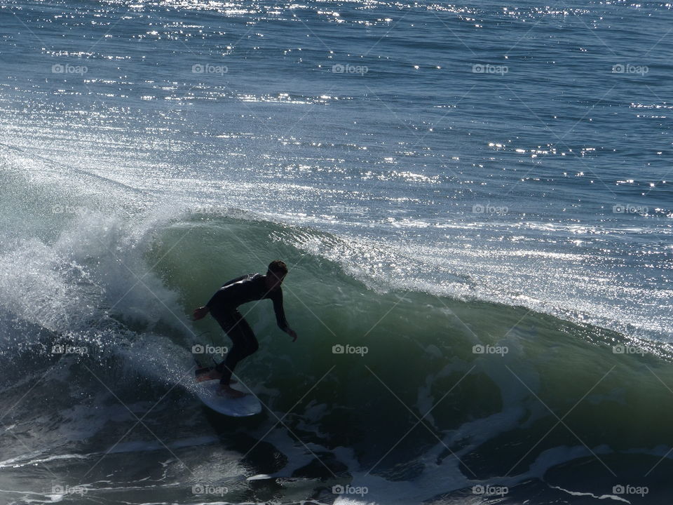 Silhouette surfer from distance