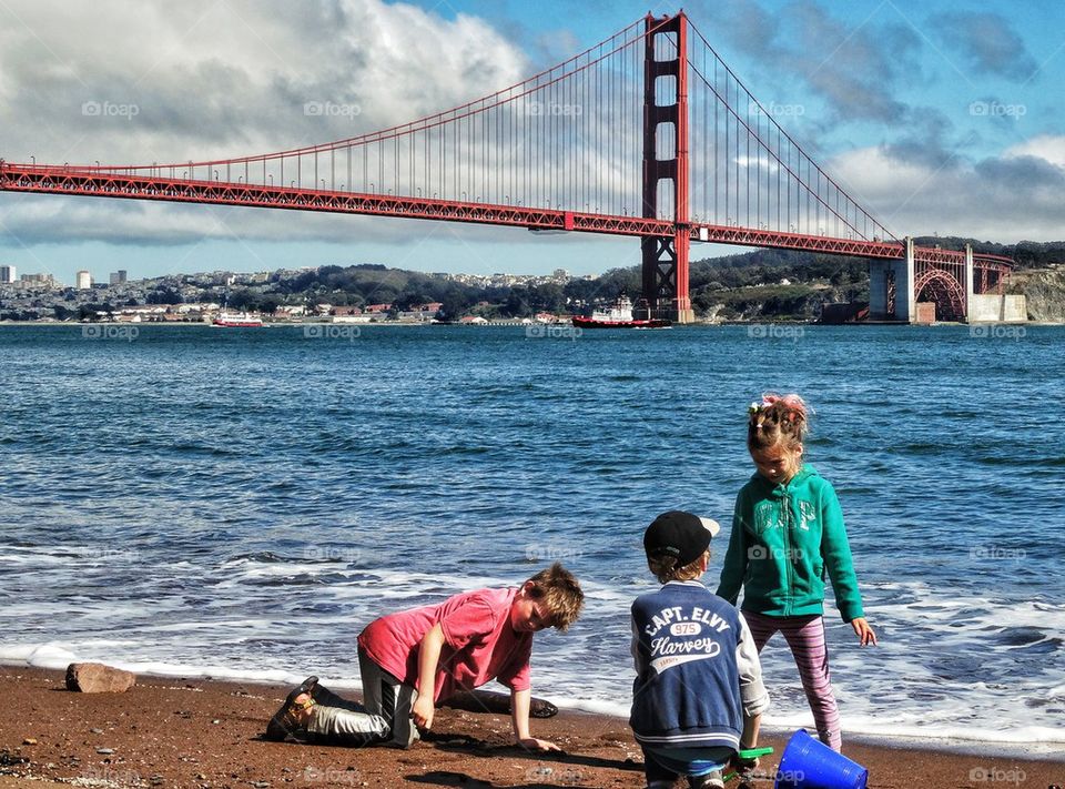 Kids In San Francisco. Playing On A Beach In San Francisco Near The Golden Gate Bridge
