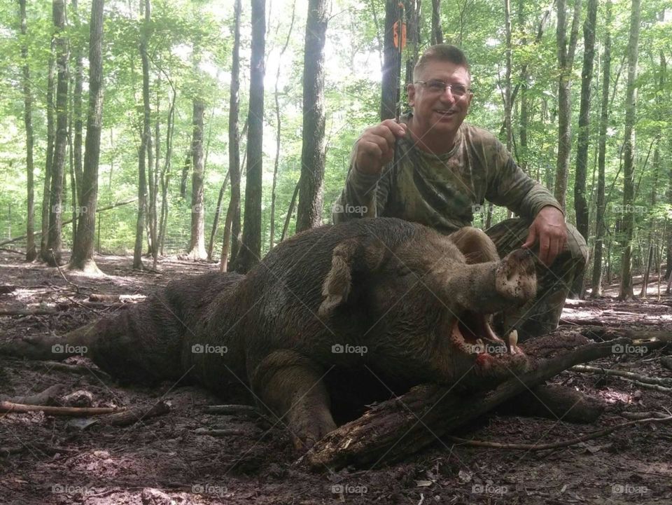 A Bow Hunter and his prey, a 650 pound Wild Bore. Hunted in Sparta, Tennessee.