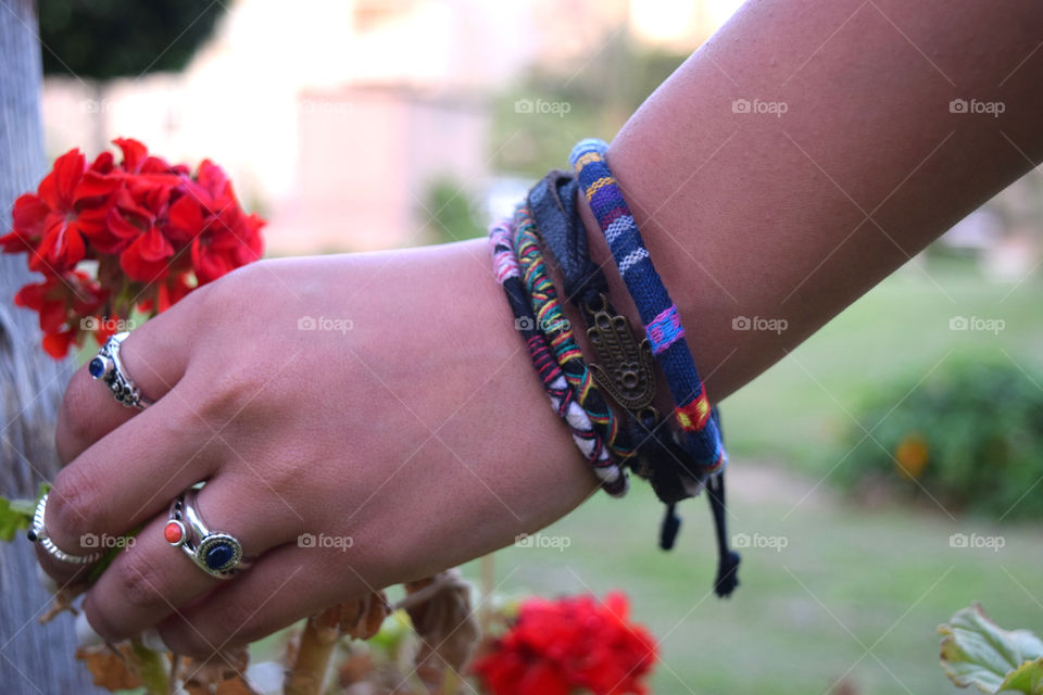 Hand holding flower with bracelet
