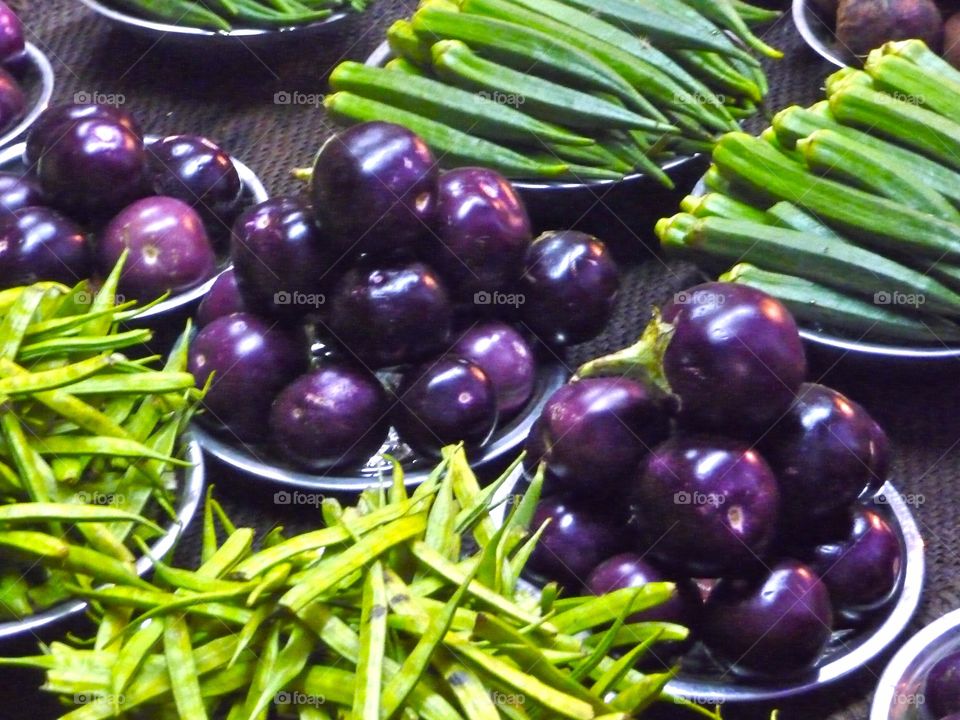 Green and violet vegetables. Vegetables on a local market stand