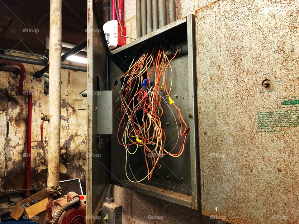 Vintage electrical pull box with cluttered wiring 