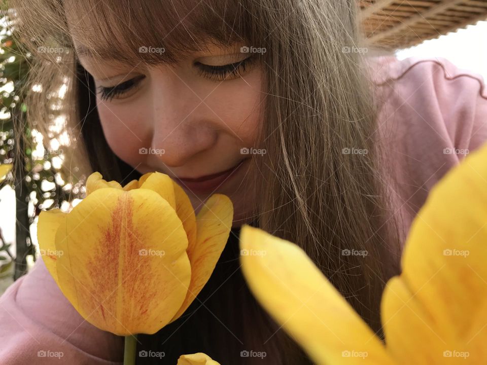 A girl with yellow tulips