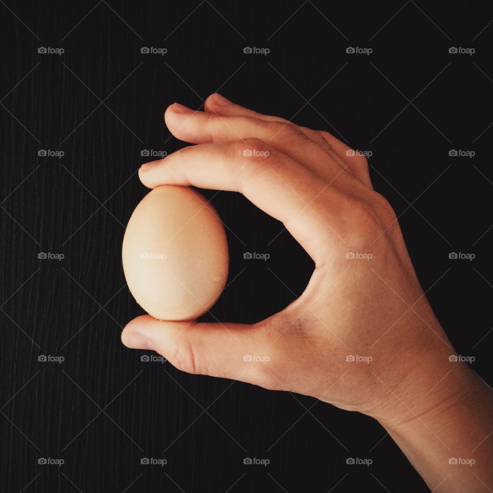 Egg holding against black background