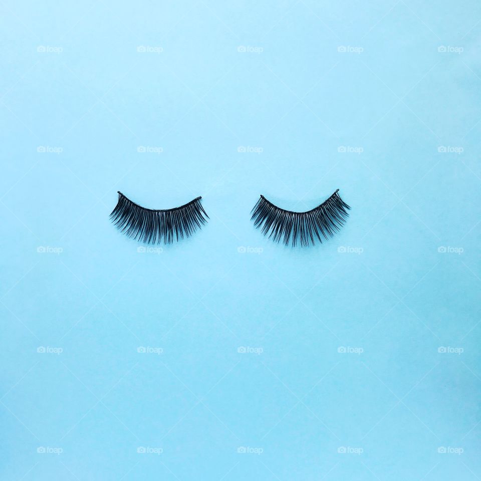 Minimalism. Eyelashes on blue background