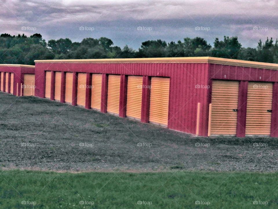 A red storage facility with yellow unit doors.