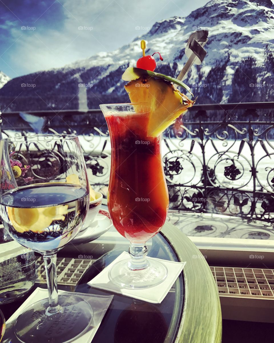 Cocktail and wine in front of a frozen lake in St Moritz. 