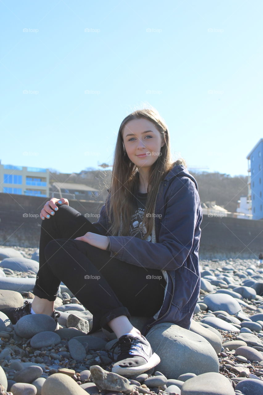 Portrait of a girl standing on pebble