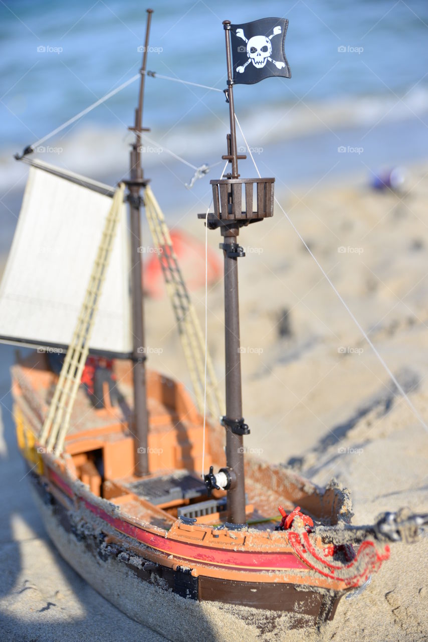 Toy ship at the beach