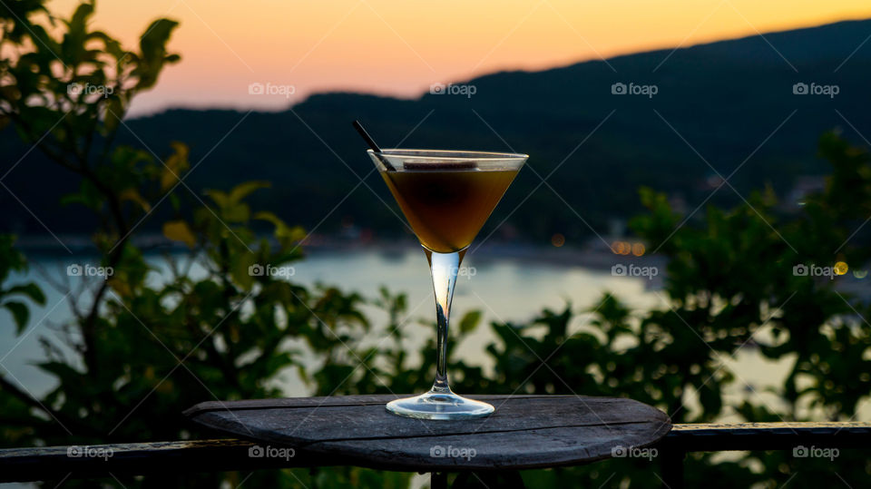 A cocktail with the sea in the background