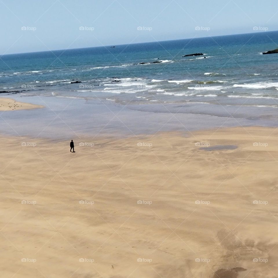 a young man walk around the beach at essaouira city in Morocco.