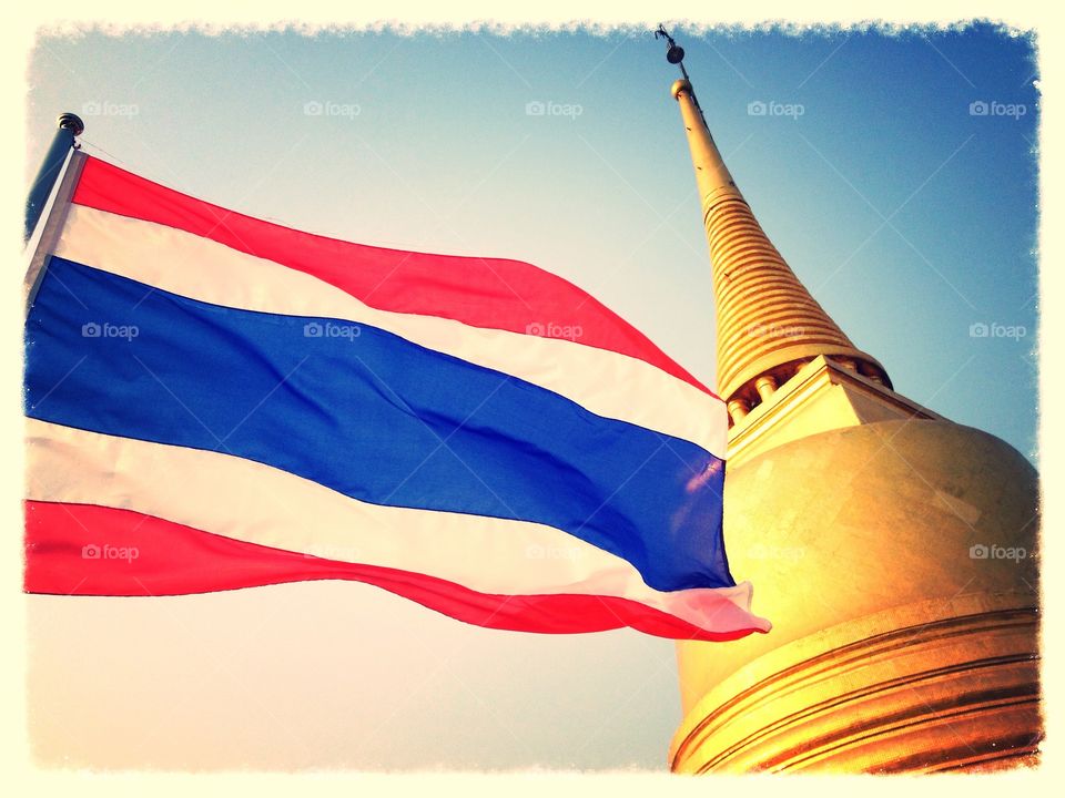 Land of Peace. Thai flag and golden pagoda