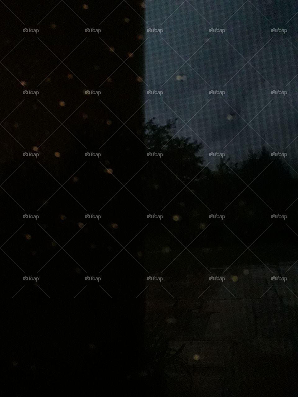 Night thunderstorm through the mosquito mesh window