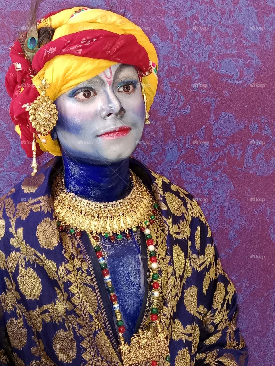 A boy in the attire of Lord krishna