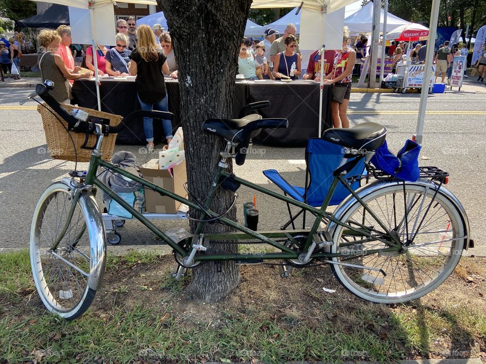 A bicycle built for two secured on a tree at a recent festival I attended. Apparently, two people rode to the event on it, which is a great idea since parking is at a premium for this popular “Festival By the Sea” which is held every September.