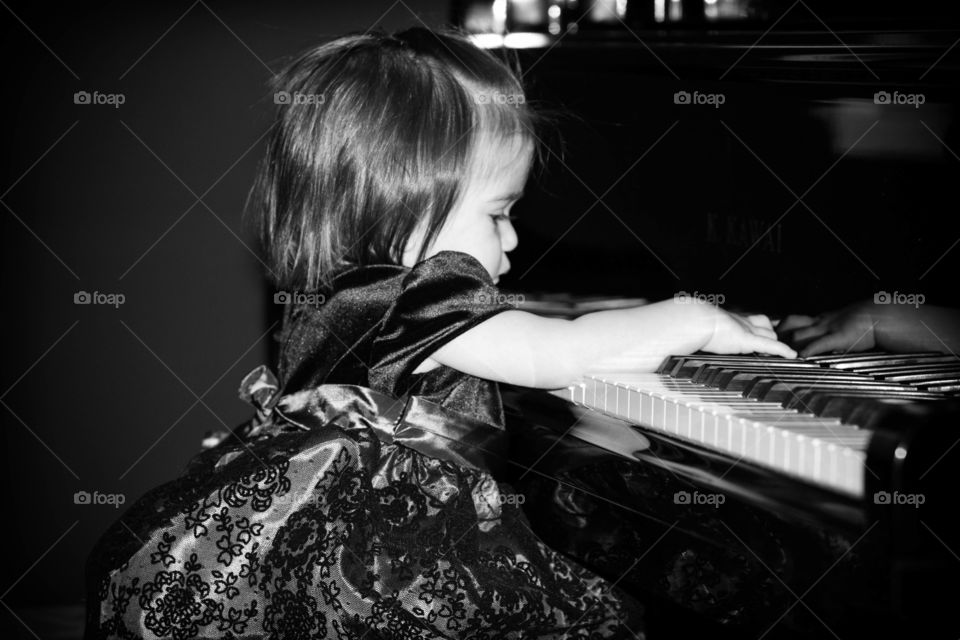 
Side view of a cute girl playing the piano