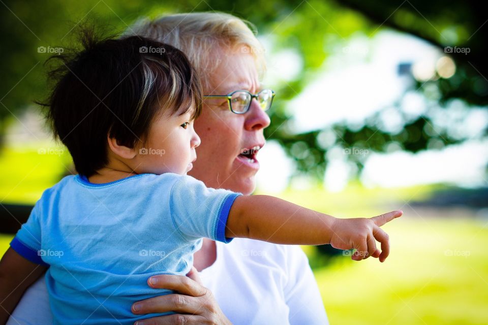 Grandmother and her grandchild discover something new together on a sunny day
