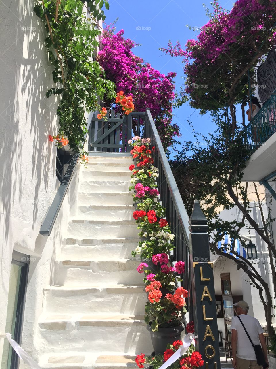Stairway adorned with colourful flowers in Mykonos Town