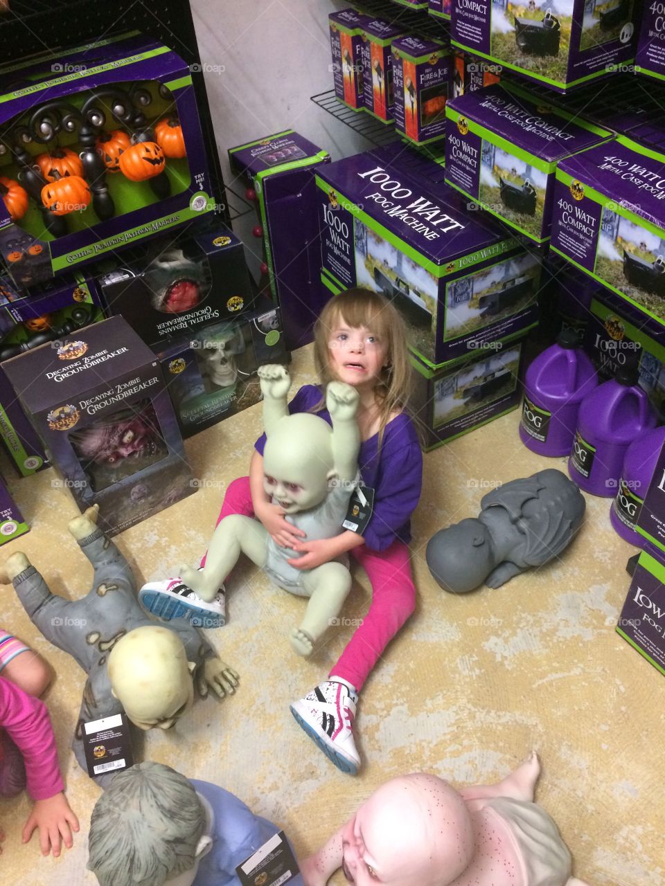 Little girl with Down syndrome at the Halloween store