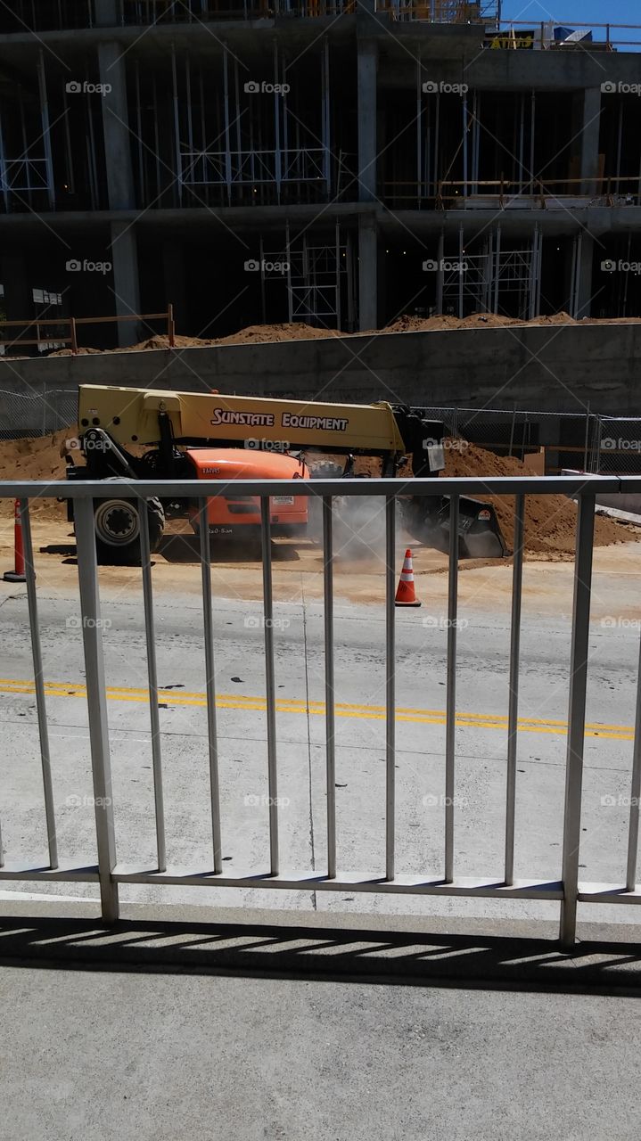 construction machinery on the other side of the fence
