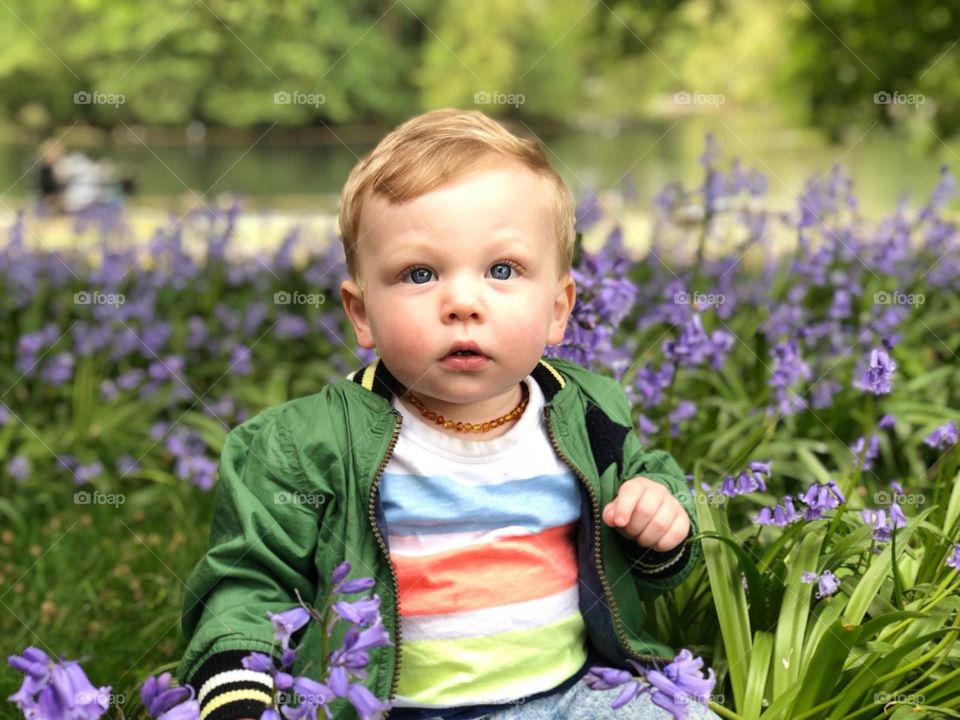 My beautiful son in the freshly sprung flower's of a park in Wolverhampton, west midlands. 
The naturally innocent look and the pure natural beauty of the surroundings make this picture what it is... perfect!