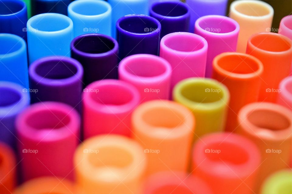Multi colored plastic pen caps