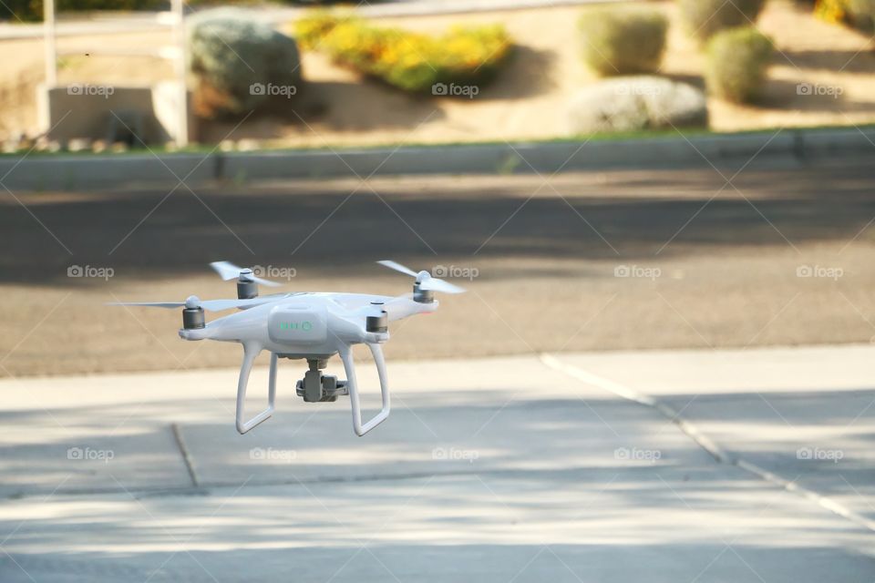Phantom 4 drone flying in neighborhood