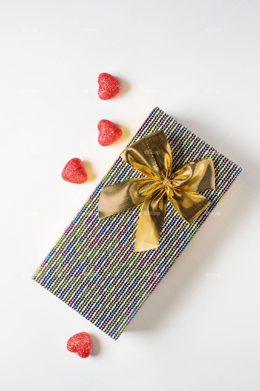 Gift with red hearts on a white background.