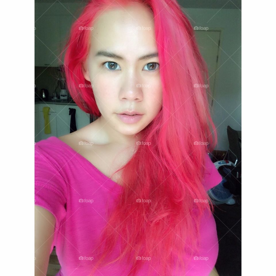 Portrait of a young woman with pink hairs