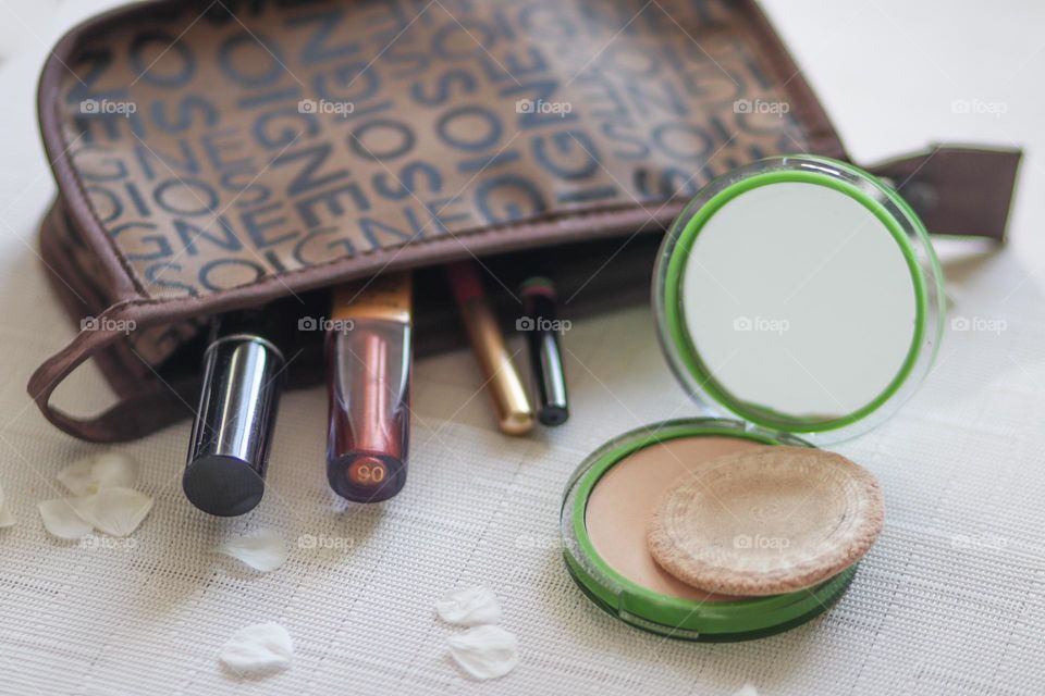 Bag with makeup and a case with face powder