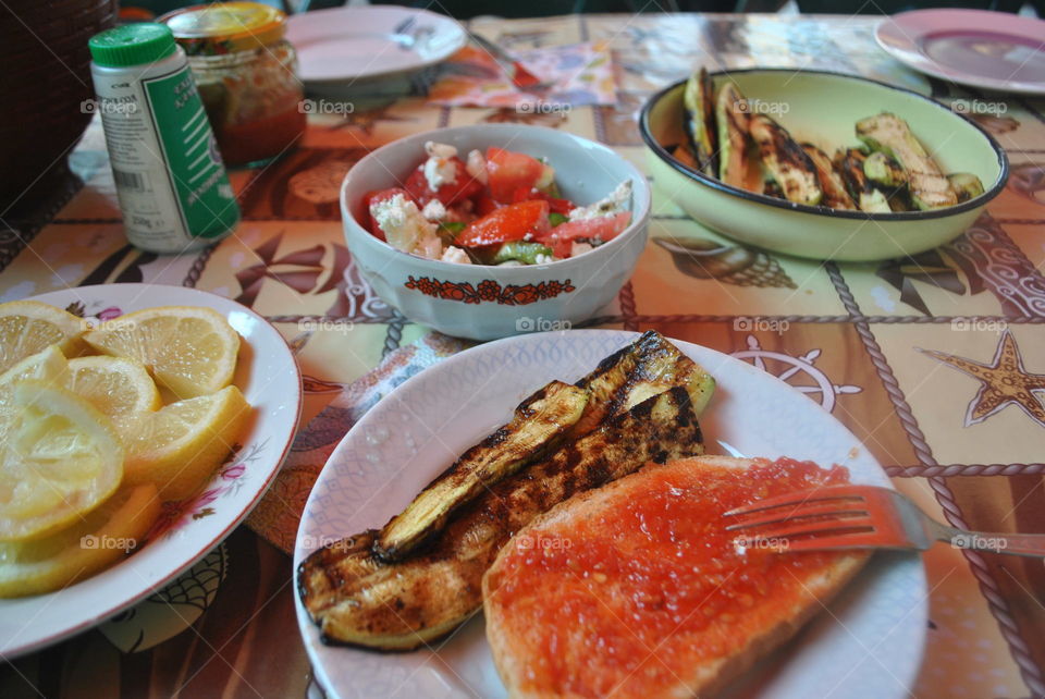 Home made dinner of salad, zucchini, vegetable spread