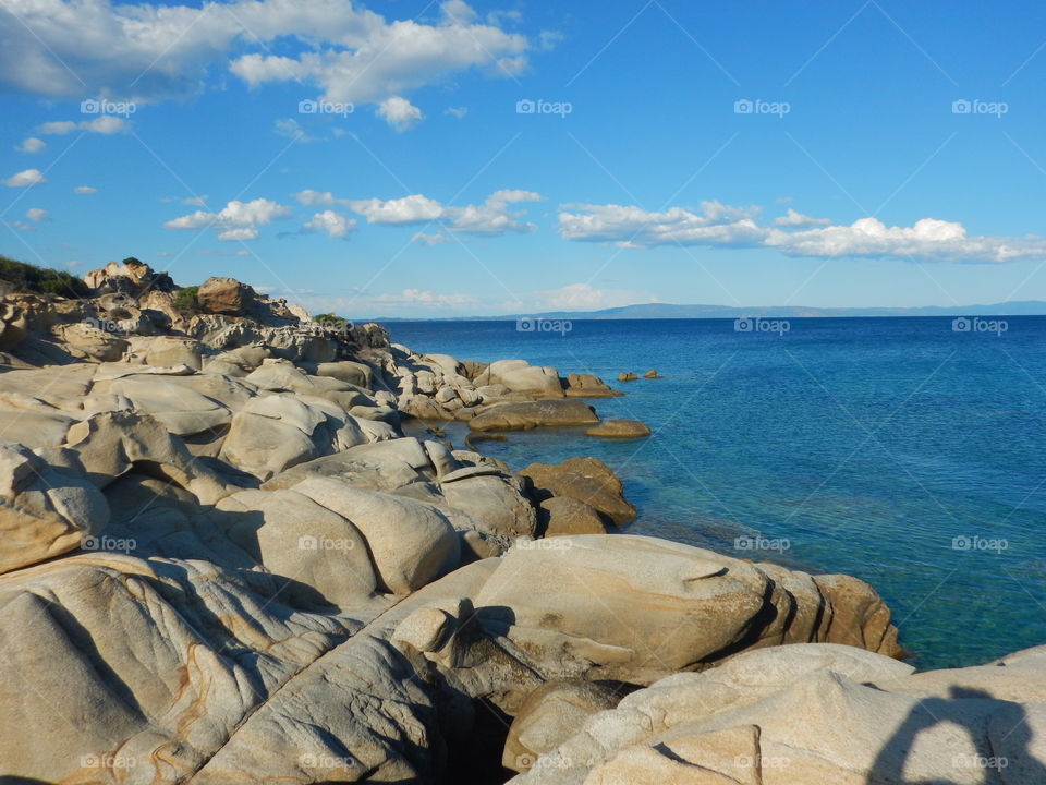a lot of rocks on the beach in sithonia,greece and beautifull view on the sea