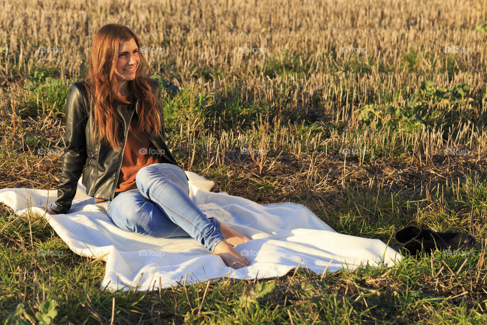 Beautiful woman sitting on blanket