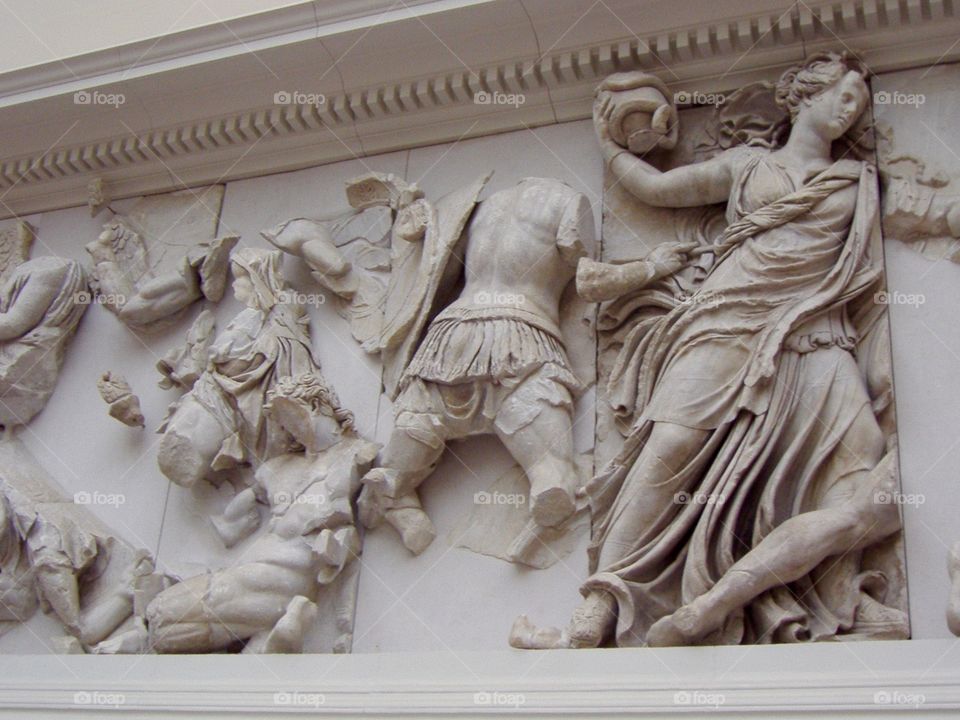 Piece of antique facade with statues