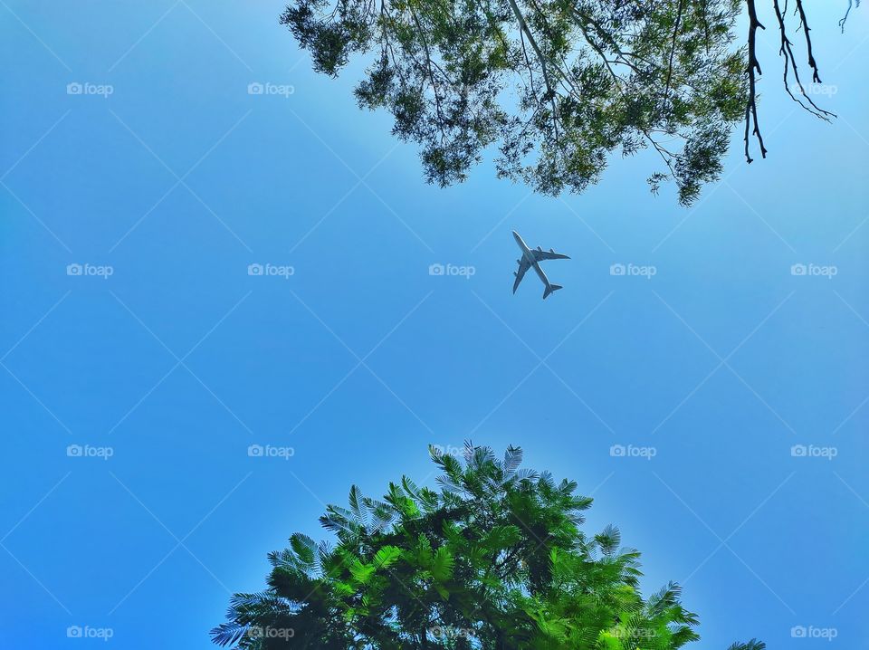 Aeroplane flying on the blue sky