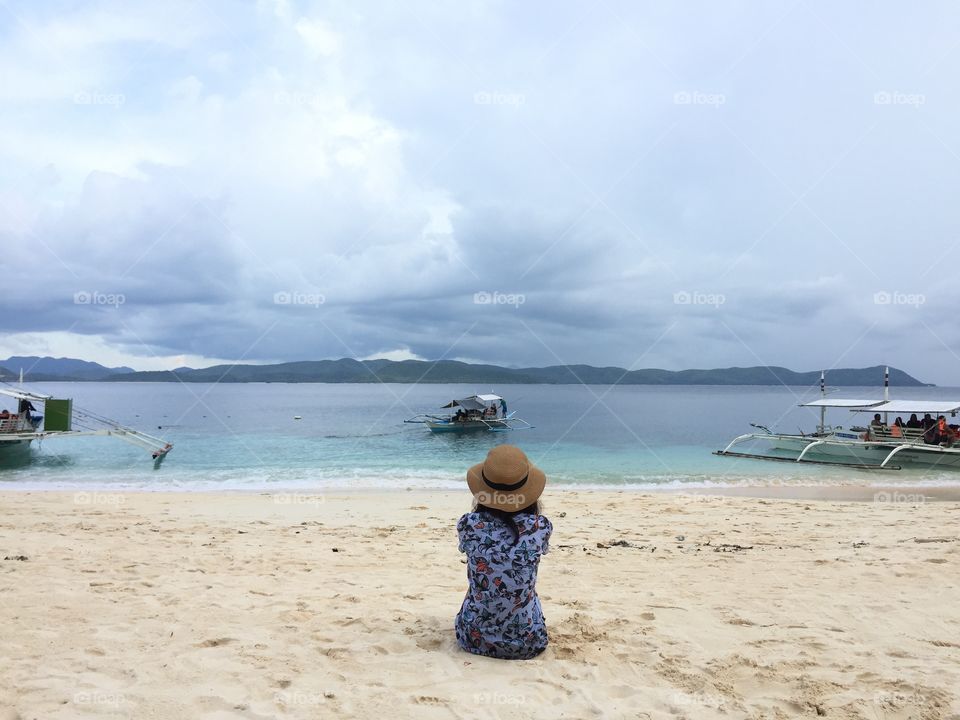 Watching the sea sitting in the sand